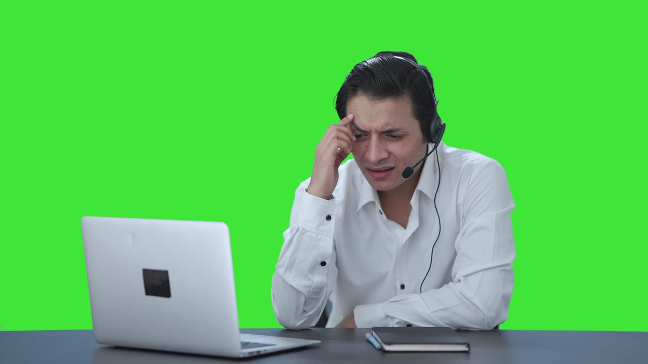 Confused Indian call center employee talking to customer Green screen