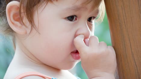 little girl picking her nose