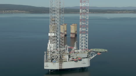 an aerial view of an oil rig on the cromarty firth on a sunny summer's day. rotating clockwise around the rig.