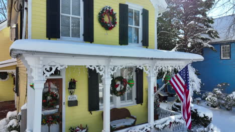 charming yellow victorian house in usa with american flag