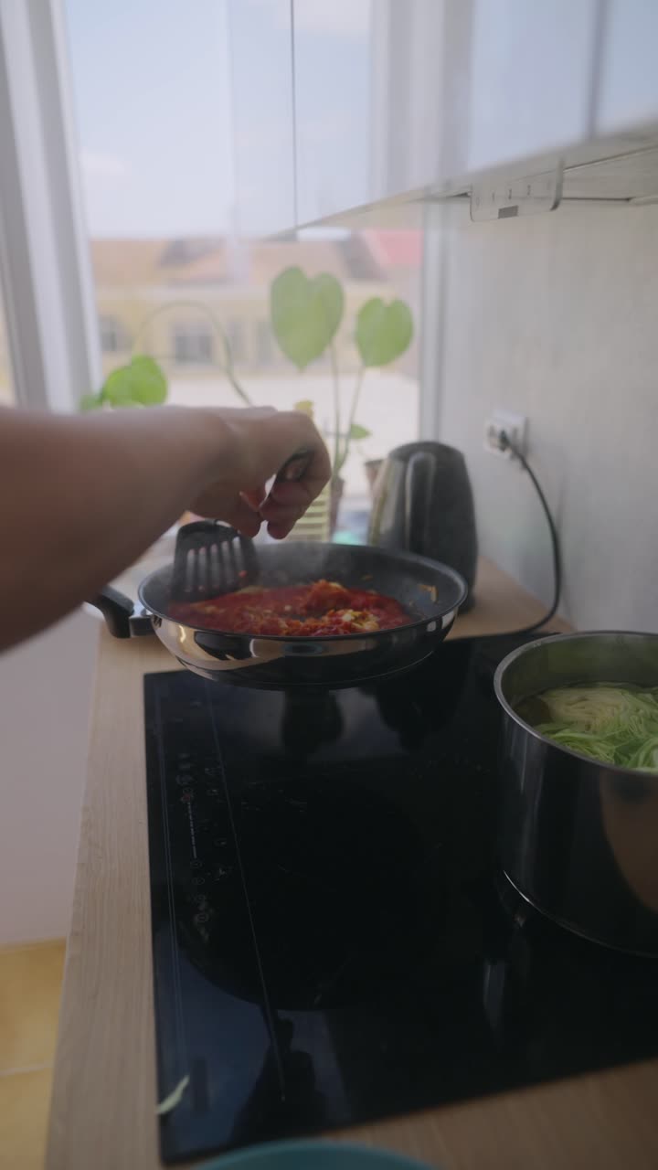 Cooking Tomato Sauce in Kitchen