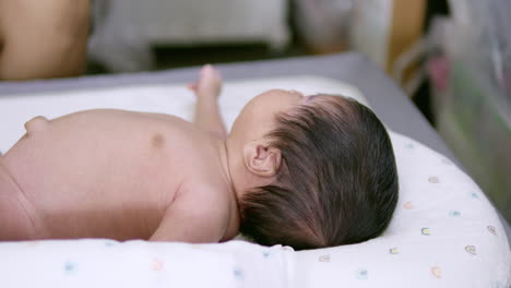 a wriggling baby who has only been born for a few days begins to recognize objects and people around the room