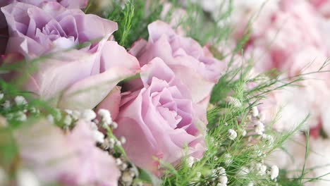 close-up of a beautiful bouquet of purple roses and baby's breath