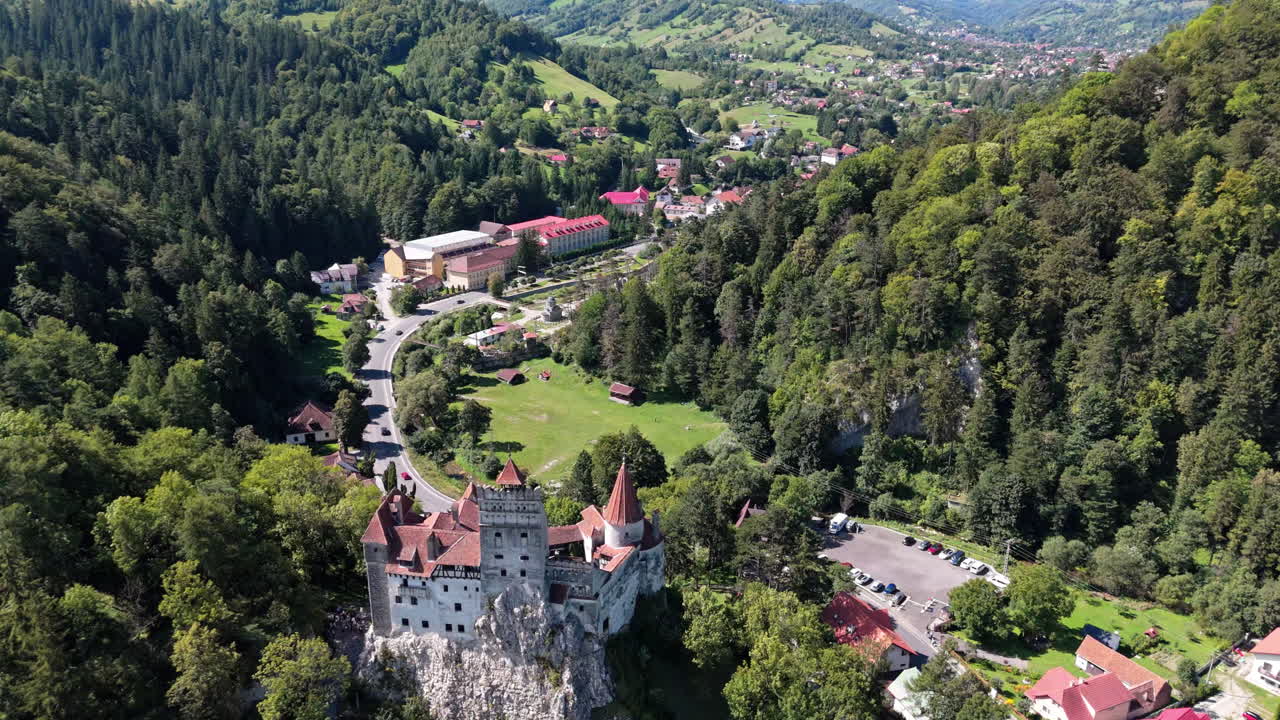 Bran Castle surrounded by lush Transylvanian landscape, captured from above