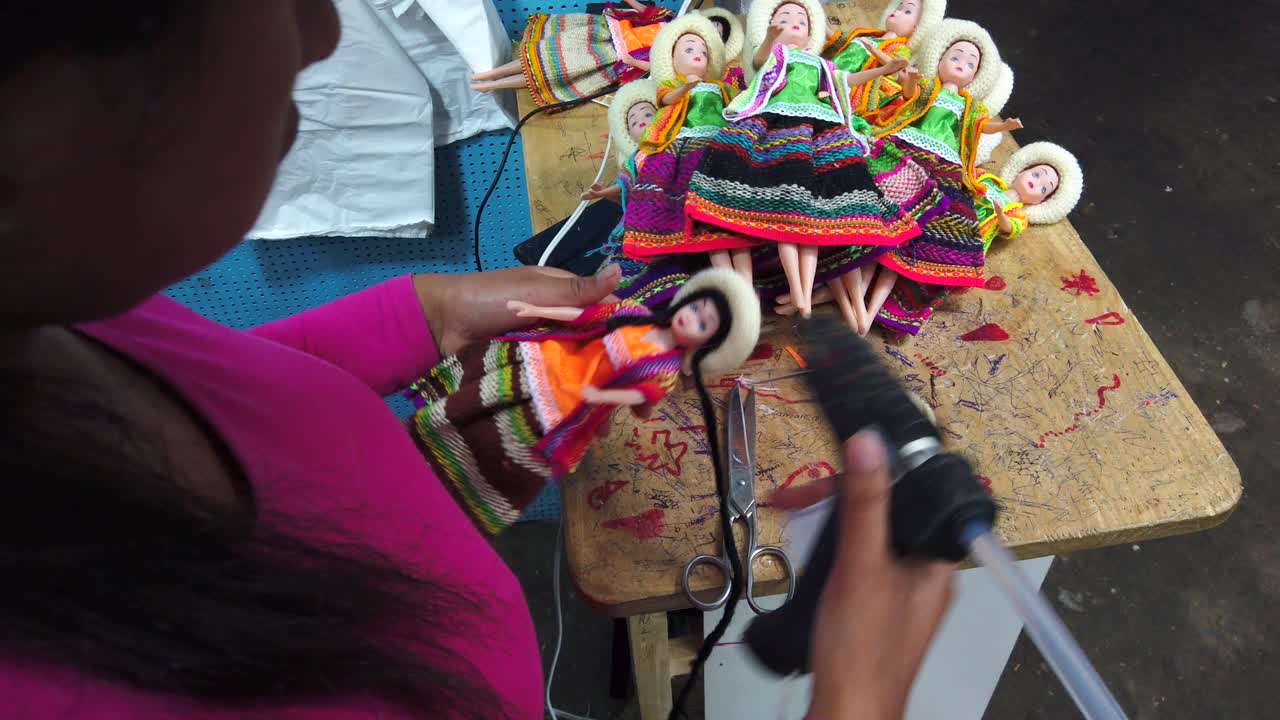 Woman handmaking souvenir dolls -Cajamarca City, Peru -Close up, slow motion