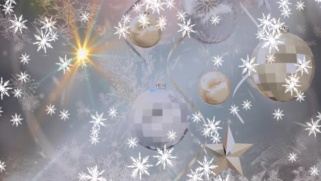 Animation-of-snow-falling-over-christmas-baubles-on-bright-background