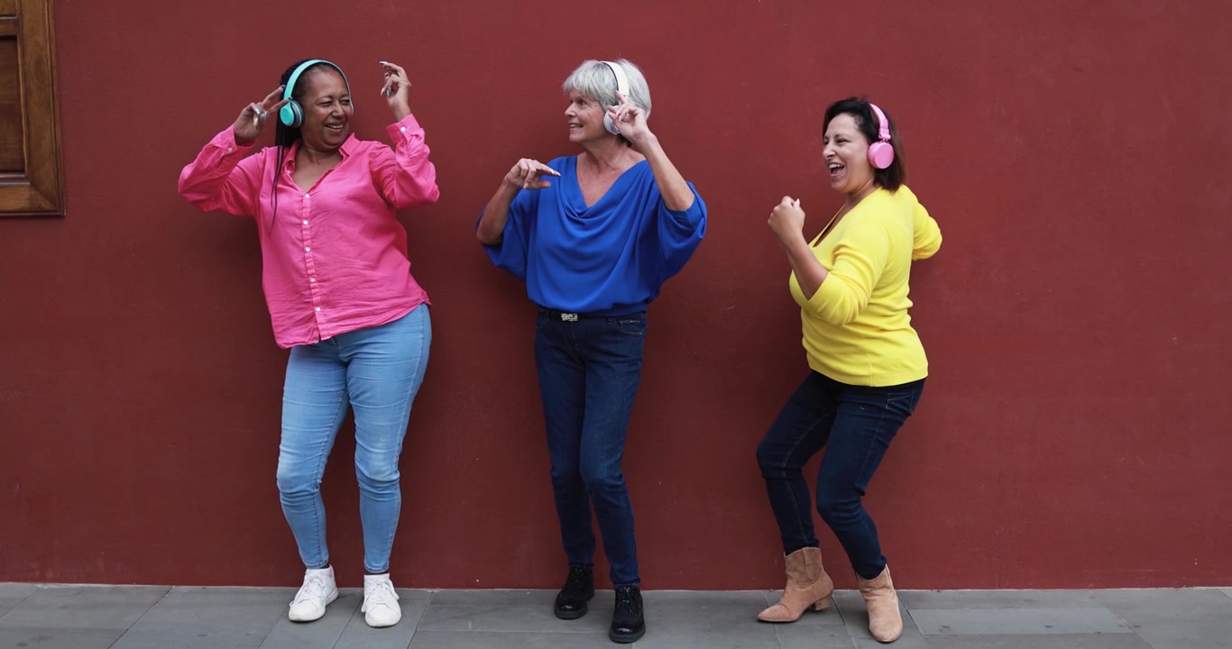 Three Diverse Mature Women Dancing and Listening to Music