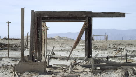 wood wreckage ruins from building stands in the lonely desert