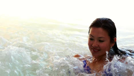 happy brunette relaxing in the jacuzzi