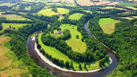 aerial pullback shot of the river tweed in scottish borders near melrose, scotland