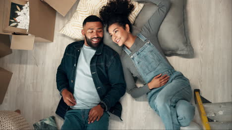 couple relaxing in new home after moving