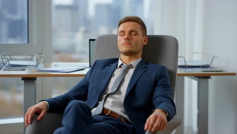 tired businessman sleeping in office chair