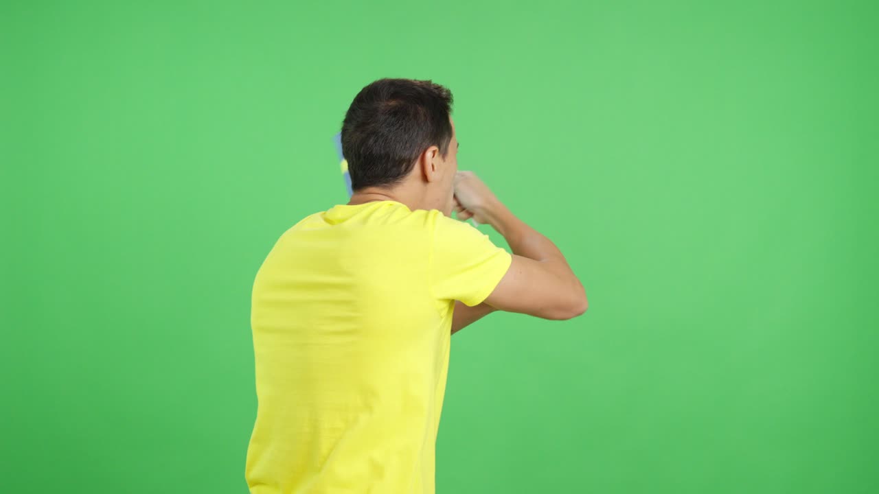 Rear view of a man waving a swedish pennant