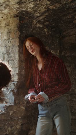 two women talking in an old building