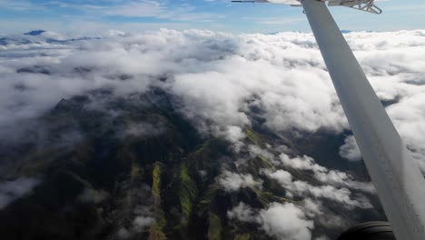 papua new guinea air travel, flight over rugged mountain peaks and clouds