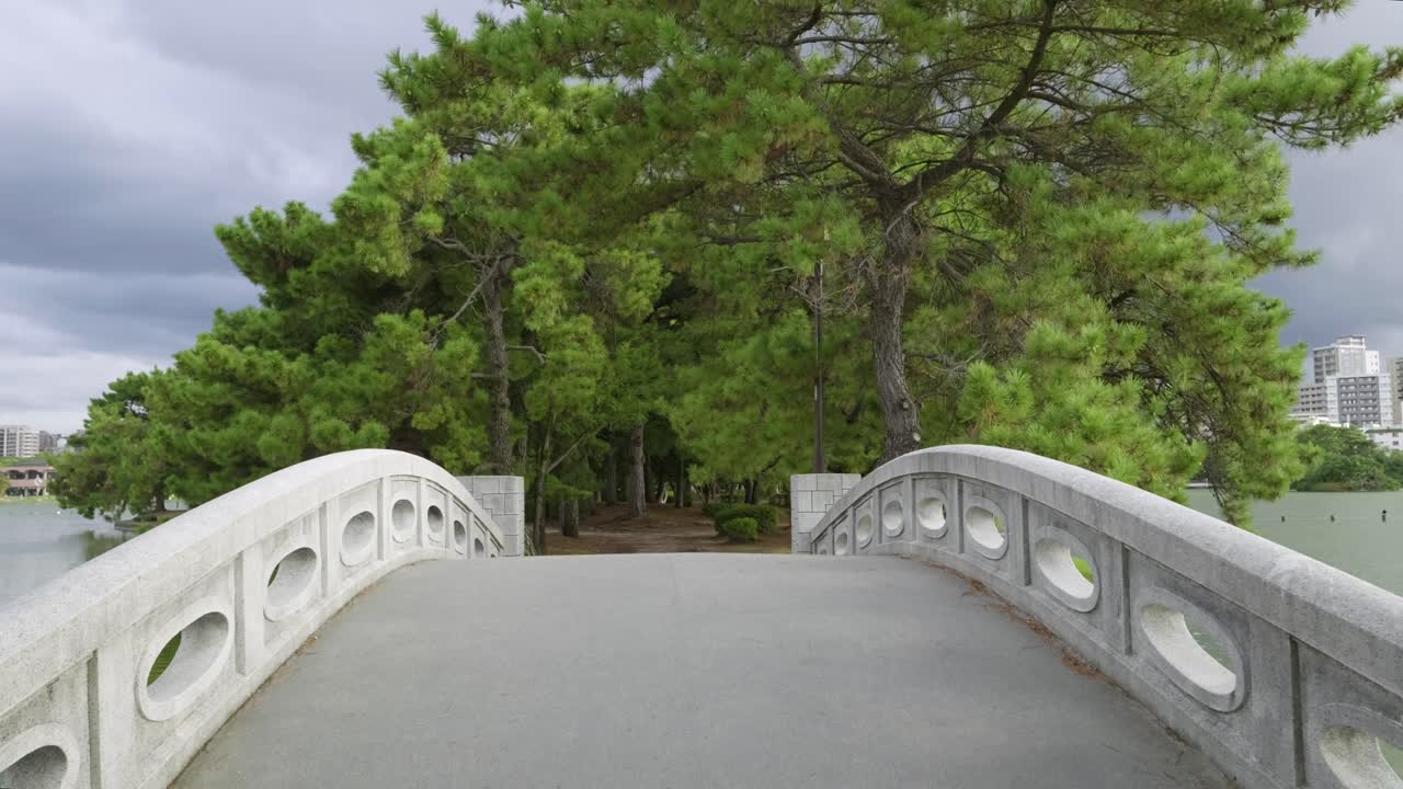 POV walking across bridge on island in Ohori Park in Fukuoka, Kyushu
