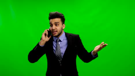 sad young businessman calling on phone over chroma key green screen latin business man solving problems serious crisis