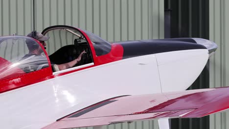 light aircraft moves forward inside a hangar.