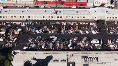 aerial view of a bustling outdoor wholesale market and parking lot