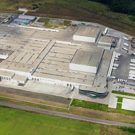 manufacturing in farmland. large industrial territory of a plant in rural place. production plant among nature. aerial view