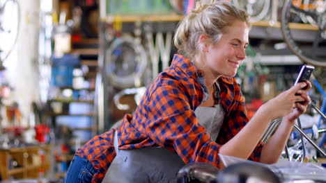 woman using mobile phone at workshop 4k