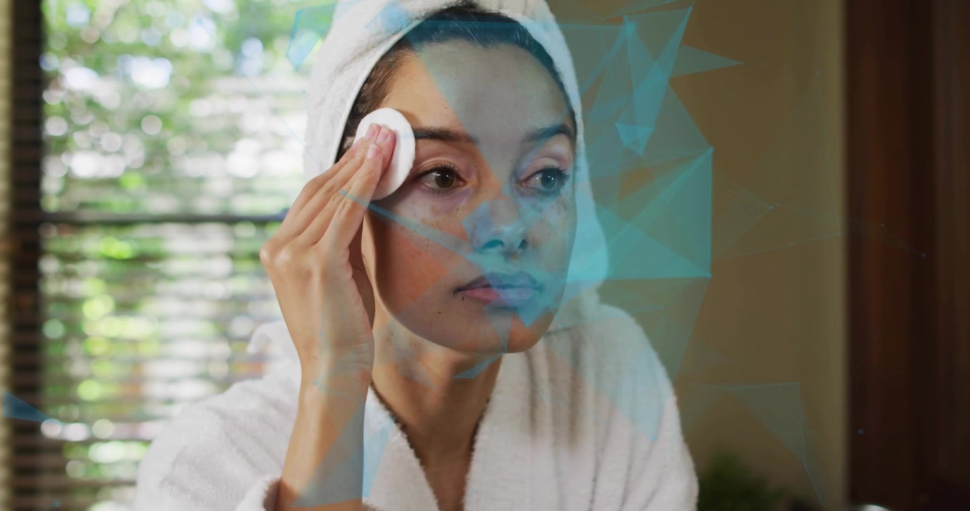 Woman pressing cotton pad against cheeks and cleansing skin while blue graphics enhancing skincare