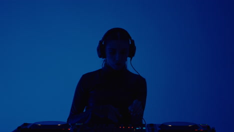 female dj performing at a music event