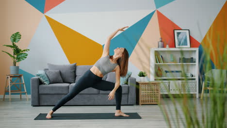 woman practicing yoga in a modern living room