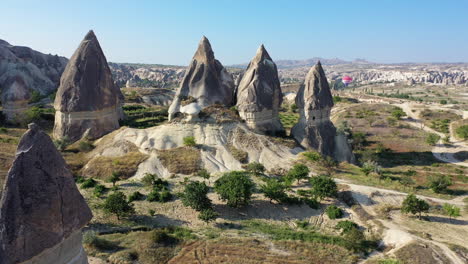 epic cinematic revealing drone shot flying through the fairy chimneys in cappadocia, turkey