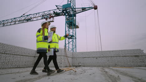 building inspection in construction site two civil engineers are walking in under-construction building