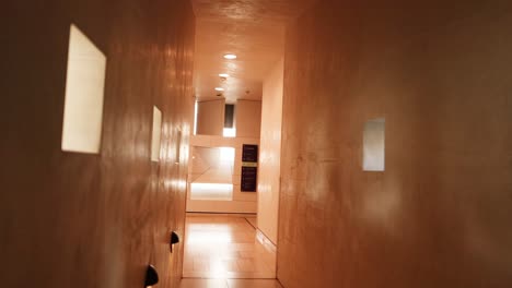 empty hallway with warm lighting and windows