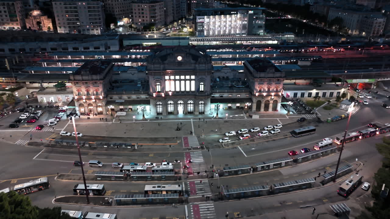 Genoa Brignole railway station and traffic on street at night, aerial view