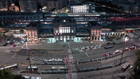 genoa brignole railway station and traffic on street at night, aerial view