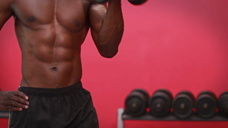 man lifting heavy dumbbell at crossfit gym