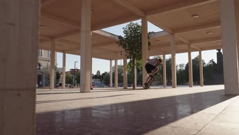 young man practicing jump tricks on skateboard. - wide shot