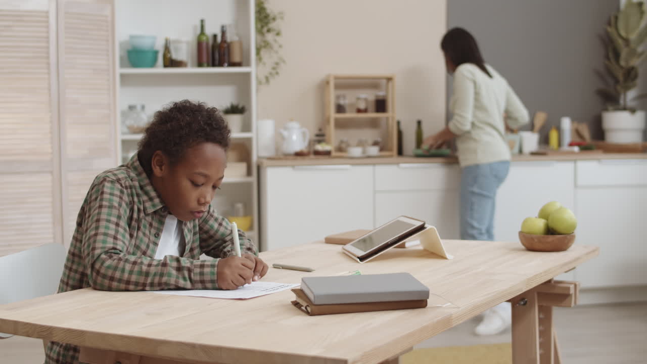 Mother Helping Child with Homework in Kitchen