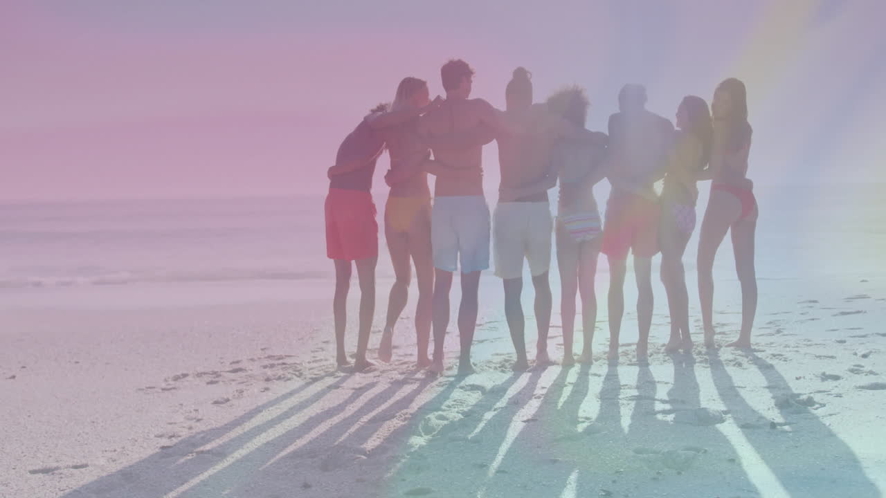 Embracing on beach, group of friends with colorful animation light effects