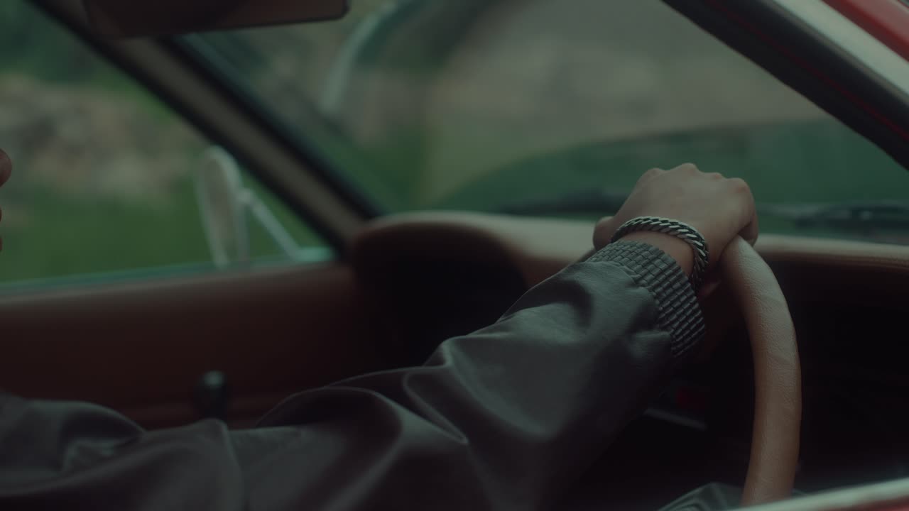 Person Driving a Classic Red Car