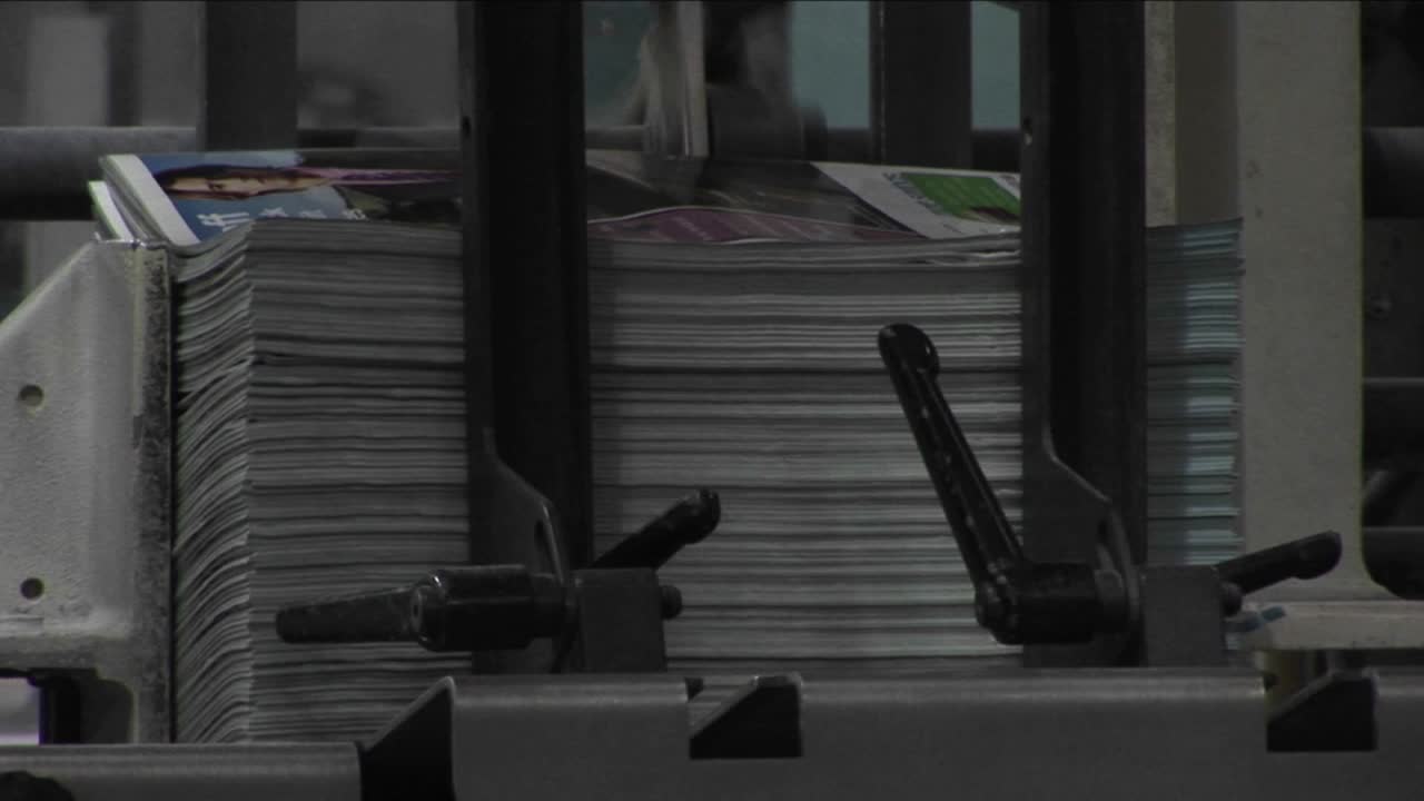 Magazine supplements are stacked in a newspaper factory