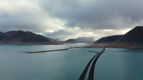 drone footage flying over a crazy road by the ocean