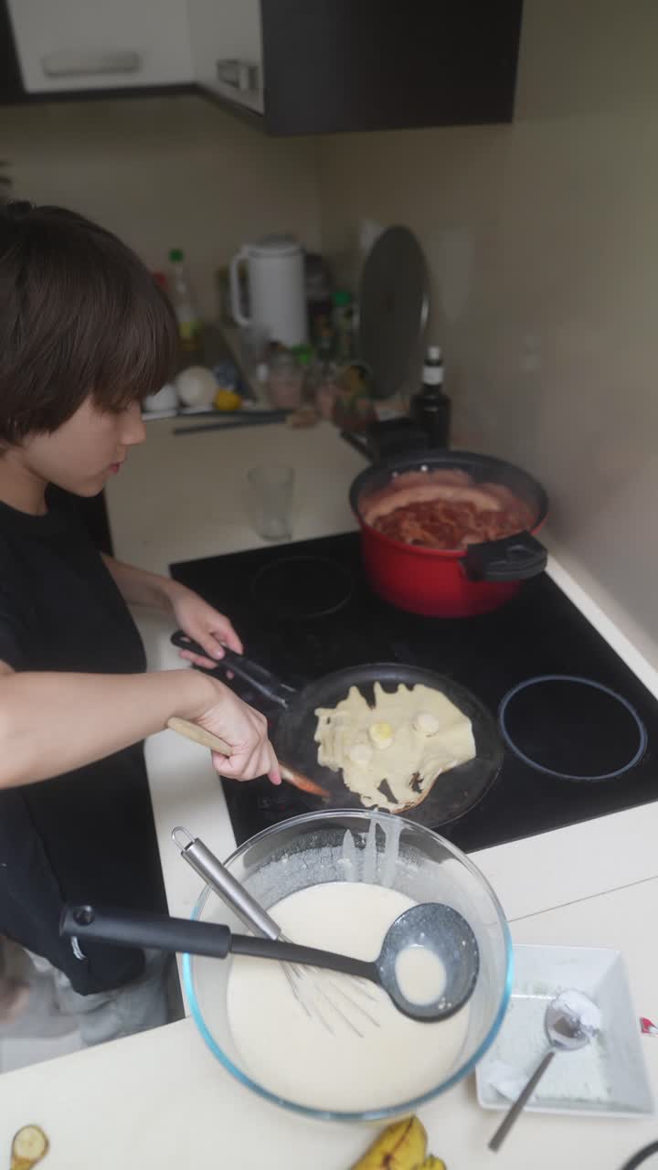 Mother and Son Cooking Pancakes Together