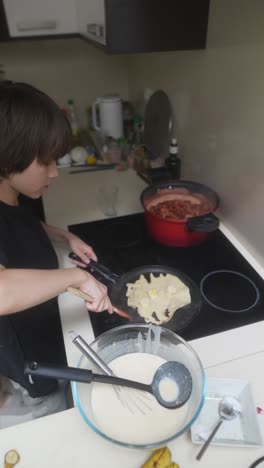 mother and son cooking pancakes together