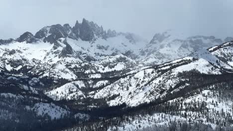 the hemlocks snowing mammoth mountain ski resort california winter spring blizzard deep powder snow misty fog foggy minarets jagged peaks vista view chairlift gray clouds mystical sunny zoom in