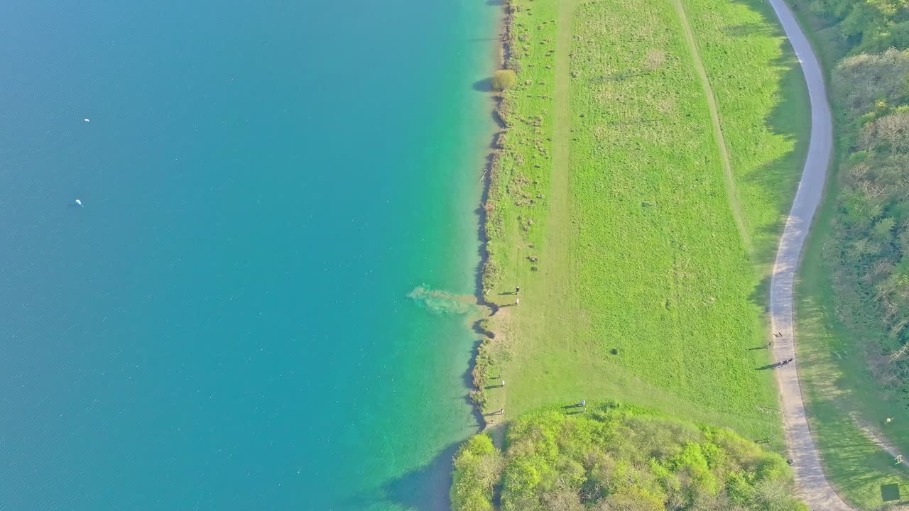 Aerial: lake during the day in Rother Valley Country Park in the Metropolitan Borough of Rotherham, South Yorkshire, England, crane down drone shot