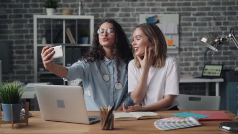two women having a video call in a modern office