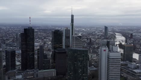 group of tall buildings in financial hub near river. aerial panoramic footage of large city. frankfurt am main, germany