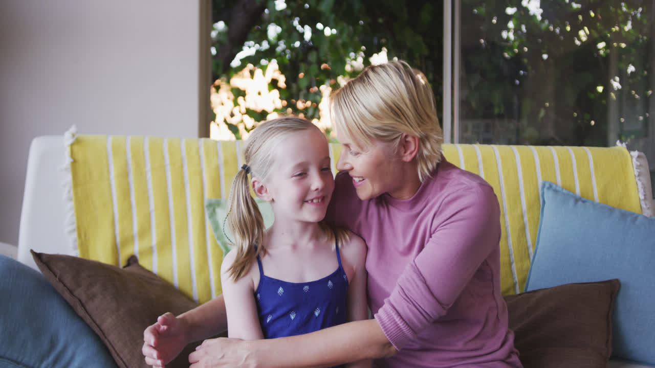 Font view of Caucasian woman playing with her daughter at home