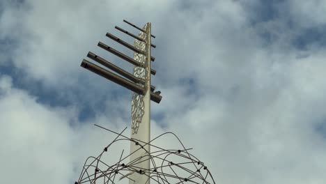 an artistic installation gracing the shores of the spanish coastline, emphasizing creative expression and the promotion of tourism, inviting visitors to explore the vibrant cultural landscape