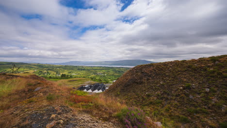 time lapse of rural landscape with hills and lake in the distance on a sunny cloudy day in arigna mountains in county leitrim in ireland