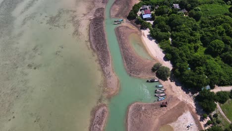 Aerial-view-over-a-beach-near-island-covered-with-green-trees-near-Koh-Samui,-Thailand